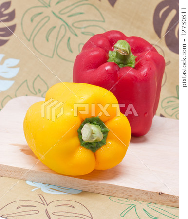Bell Peppers on a Wooden Cutting Board. Bell Peppers on a Wooden Cutting Board. 12730311