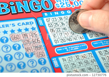 Scratching lottery ticket called bingo. Scratching lottery ticket called bingo. 12730776