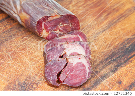 sliced horse meat sausage kazi close up on board 12731340