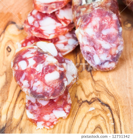 sliced dried smoked sausage on cutting wood board sliced dried smoked sausage on cutting wood board 12731342