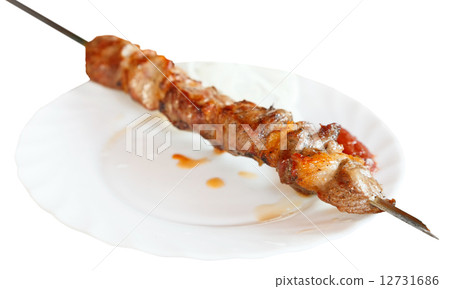 skewer of lamb shishkebab on white plate isolated 12731686