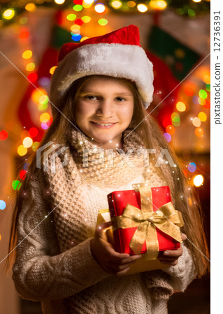 portrait of beautiful smiling girl holding gift box at Christmas portrait of beautiful smiling girl holding gift box at Christmas 12736391