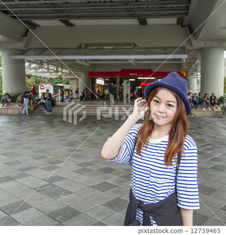 Asian woman outside subway station 12739465