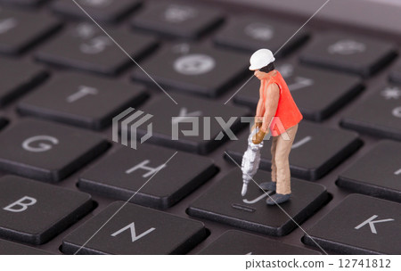 Miniature worker with drill working on keyboard Miniature worker with drill working on keyboard 12741812