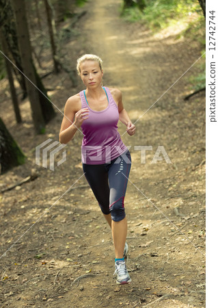 Pretty young girl runner in the forest.  12742744