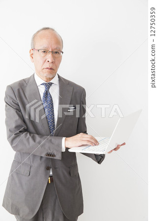 Senior businessman with a PC 12750359
