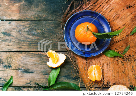Tangerine on blue plate 12754246