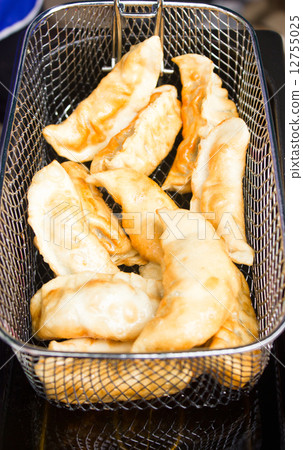 Gyoza deep fried in stove. Gyoza deep fried in stove. 12755025