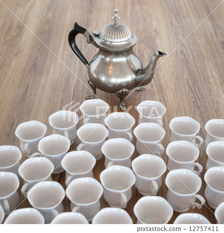 Vintage Coffee Pot On Wooden Surface With Many White Cups 12757411