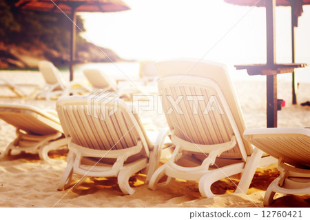 Row of beach chairs on the sea Row of beach chairs on the sea 12760421