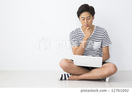 A young man with a computer A young man with a computer 12761092