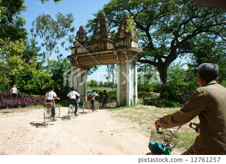 Group Asian kids, riding bike, Khmer village gate 12761257