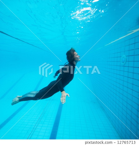 Female diver flying underwater Female diver flying underwater 12765713