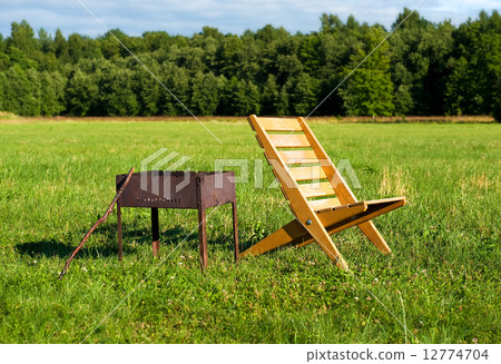 Armchair and barbecue outdoors Armchair and barbecue outdoors 12774704