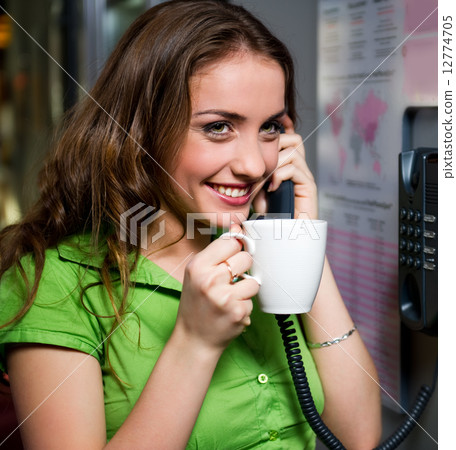 Cheerful young woman talking on the phone Cheerful young woman talking on the phone 12774705