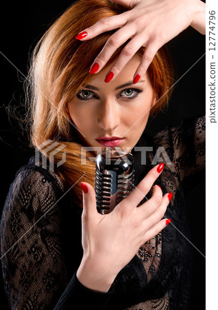 Gorgeous stylish redhead woman with retro microphone 12774796