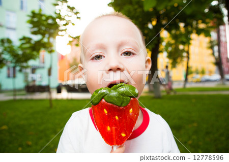 young boy with colorful lollipop 12778596