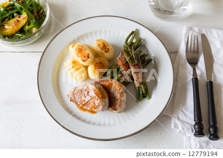 Pork medallions with potatoes and beans 12779194