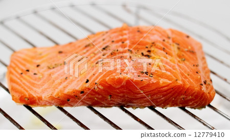 Marinated salmon fillet on grill 12779410