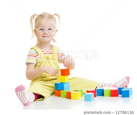 Funny kid in eyeglases playing building blocks isolated Funny kid in eyeglases playing building blocks isolated 12786136