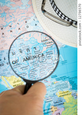 Image of magnifier grass on world map. 12786570