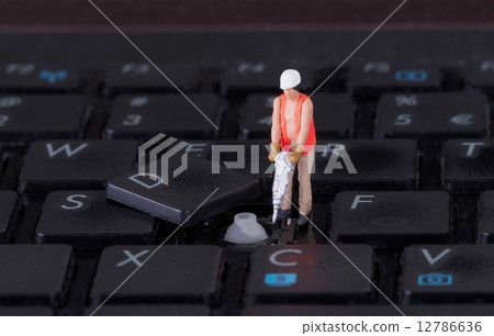 Miniature worker with drill working on keyboard Miniature worker with drill working on keyboard 12786636