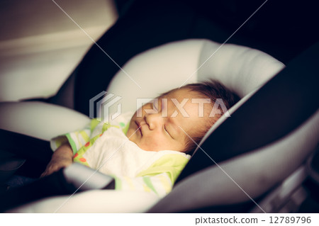 Baby sleeping on a child seat Baby sleeping on a child seat 12789796
