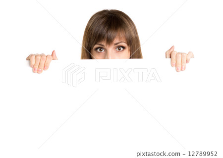 Portrait of young beautiful woman behind white blank board. 12789952