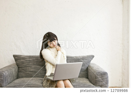 A woman tired from personal computer operation A woman tired from personal computer operation 12789986