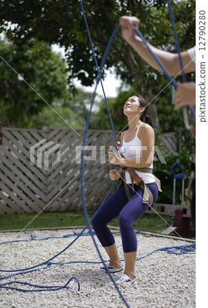 Asian Woman in belaying stance in outdoor rockclimb 12790280