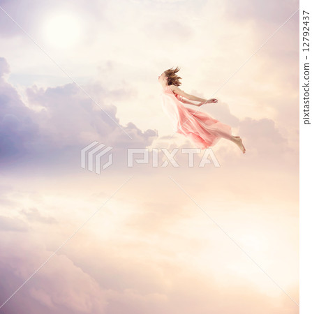 A young woman flying in the sky 12792437