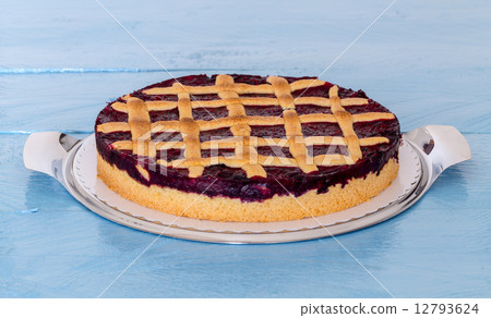 Grid rustic cake with forest berries on blue wood 12793624