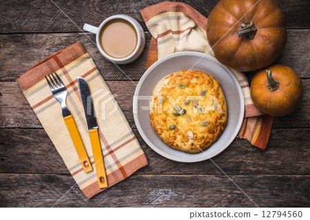 Breakfast coffee and flat cake with pumpkin seeds on wooden tabl Breakfast coffee and flat cake with pumpkin seeds on wooden tabl 12794560