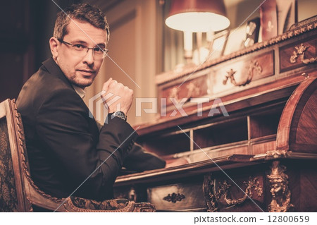 Confident middle-aged man in luxury vintage style interior Confident middle-aged man in luxury vintage style interior 12800659