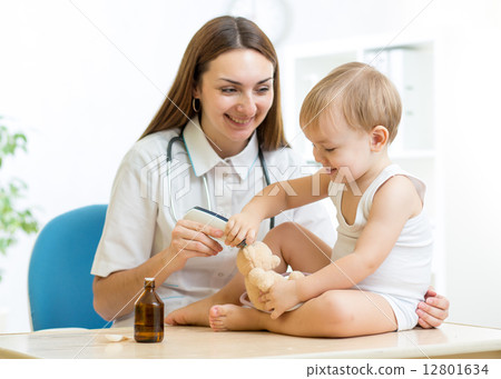 doctor examining happy child boy 12801634