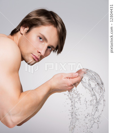 Man washing his face with water. Man washing his face with water. 12804431