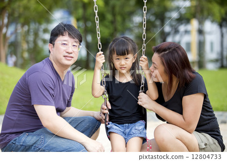 Young Asian family in park playing swing 12804733