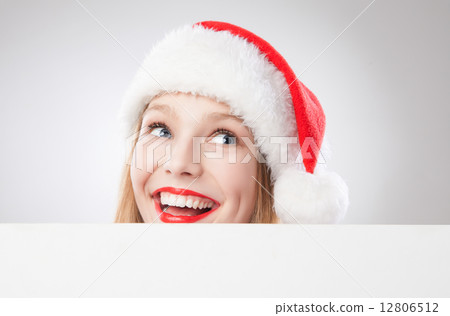 Christmas woman in santa hat holding empty board Christmas woman in santa hat holding empty board 12806512