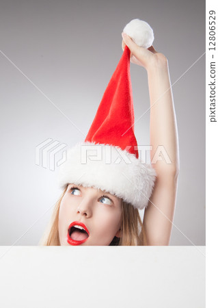 Christmas woman in santa hat holding empty board Christmas woman in santa hat holding empty board 12806529
