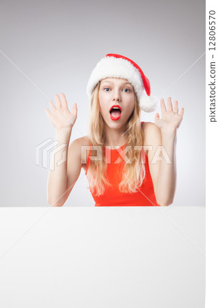 Christmas woman in santa hat holding empty board Christmas woman in santa hat holding empty board 12806570