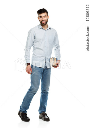 Young bearded smiling man with books in hand on white Young bearded smiling man with books in hand on white 12806812