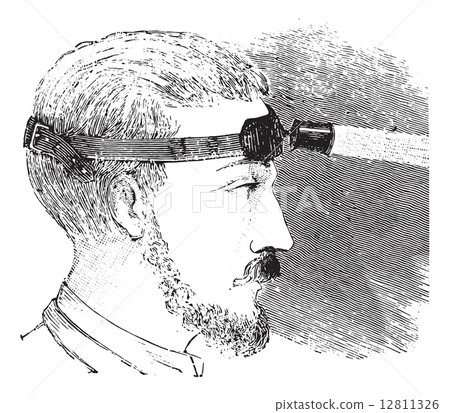 Man with electric light attached to strap on forehead, vintage e Man with electric light attached to strap on forehead, vintage e 12811326