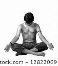 A young Indian modern man meditatin in lotus pose 12822069