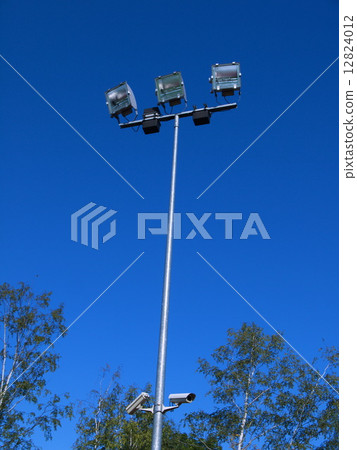Stadium light against blue sky Stadium light against blue sky 12824012