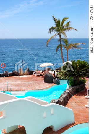 View on the beach, palms and swimming pool of luxury hotel, Tene View on the beach, palms and swimming pool of luxury hotel, Tene 12827513