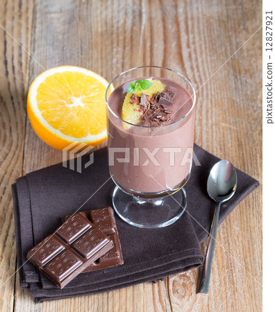 Chocolate pudding dessert with orange and grated chocolate 12827921