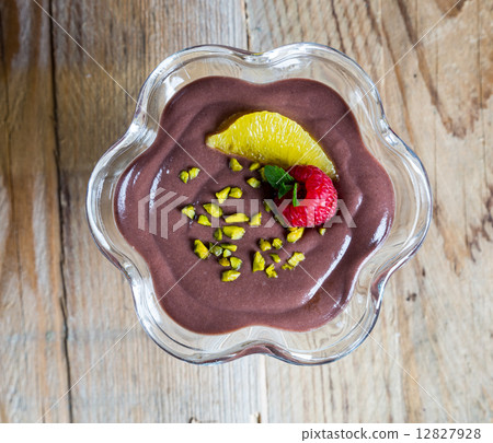 Chocolate pudding dessert with orange and pistachio 12827928