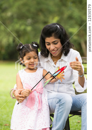 Happy Indian mother and daughter playing in the park. Lifestyle 12830579