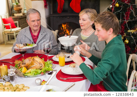 Smiling extended family at the christmas dinner table Smiling extended family at the christmas dinner table 12838643