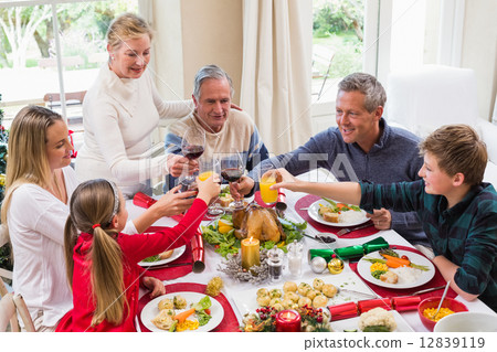 Family toasting with red wine in a christmas dinner Family toasting with red wine in a christmas dinner 12839119